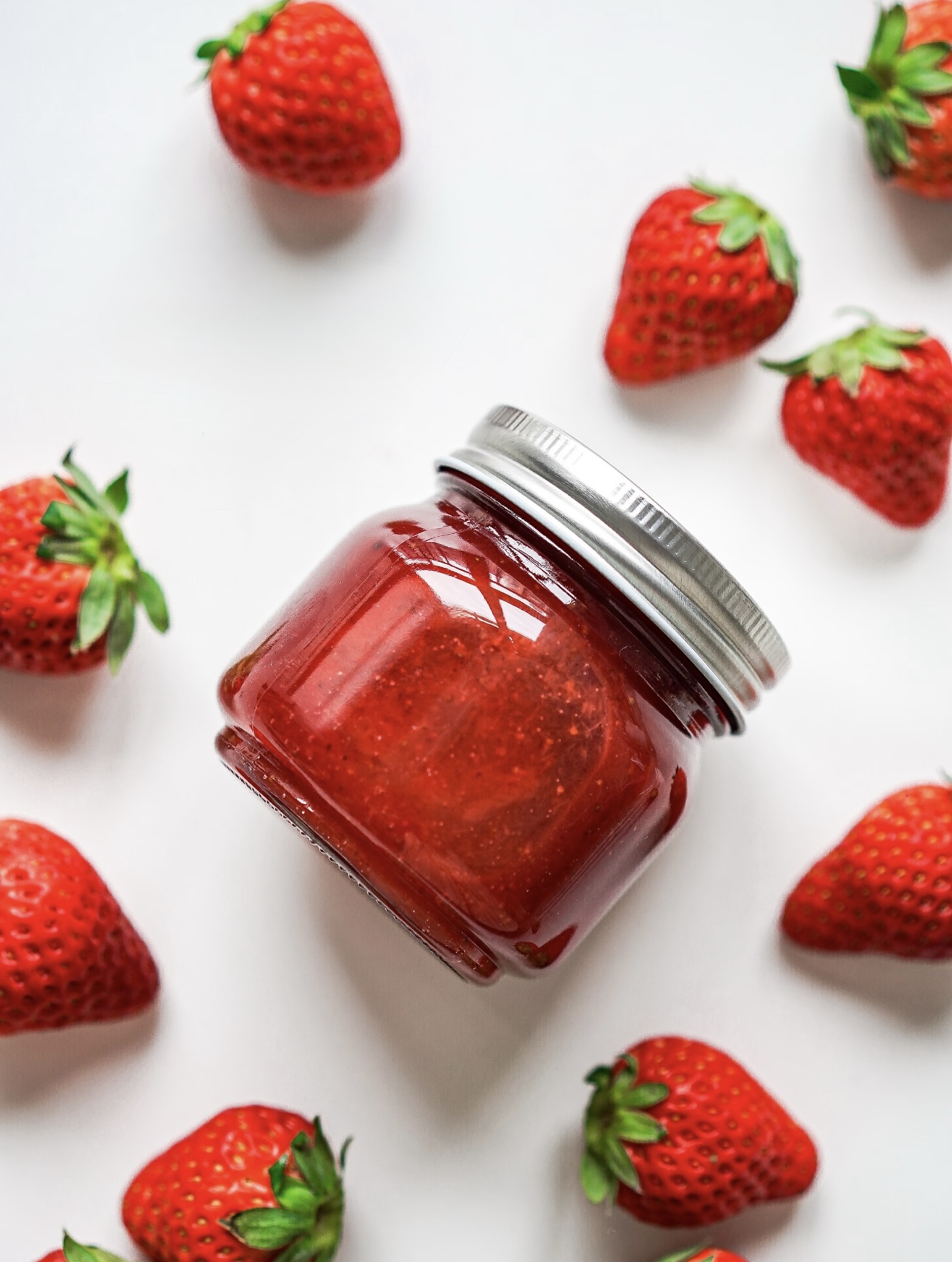 Strawberry jam gently simmering in the pot