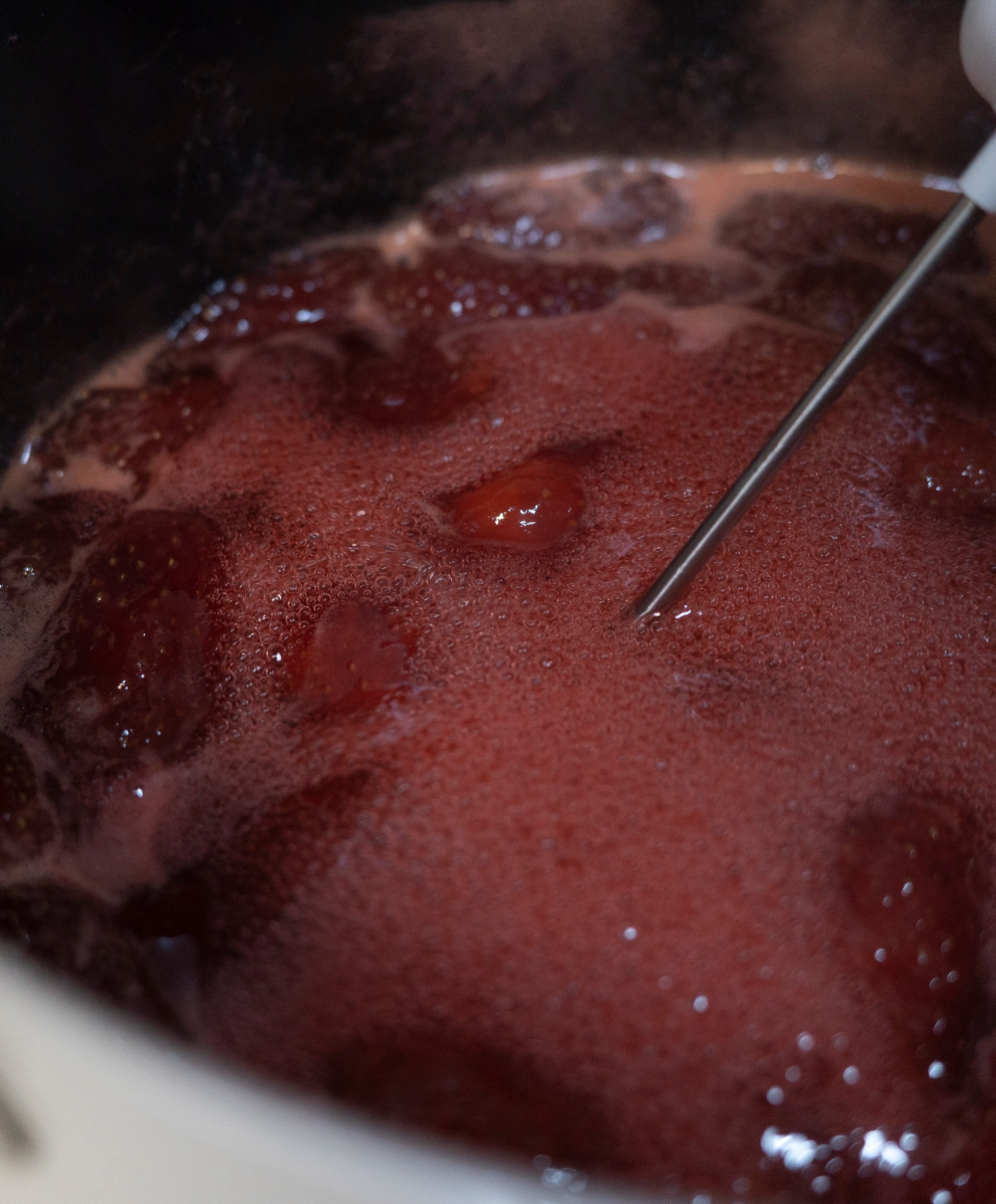 Strawberry jam in a jar with fresh berries